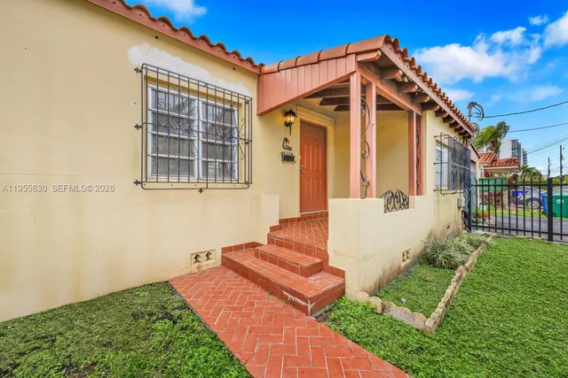 a front view of a house with garden