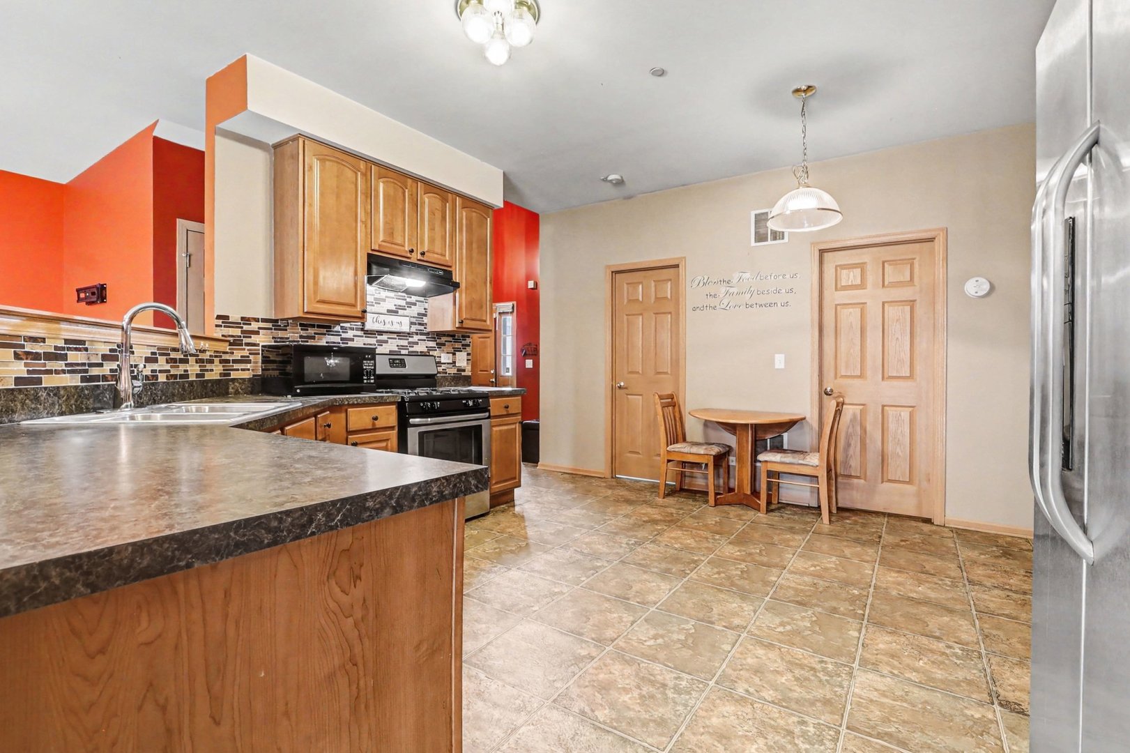 6503 Blue Sky Lane Matteson, IL 60443 - Photo 9 of 23 a kitchen with stainless steel appliances granite countertop a stove and a refrigerator