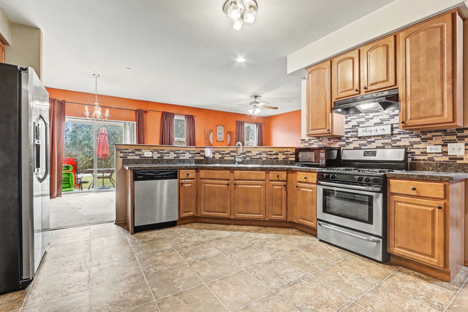 6503 Blue Sky Lane Matteson, IL 60443 - Photo 10 of 23 a kitchen with stainless steel appliances granite countertop a stove sink and cabinets