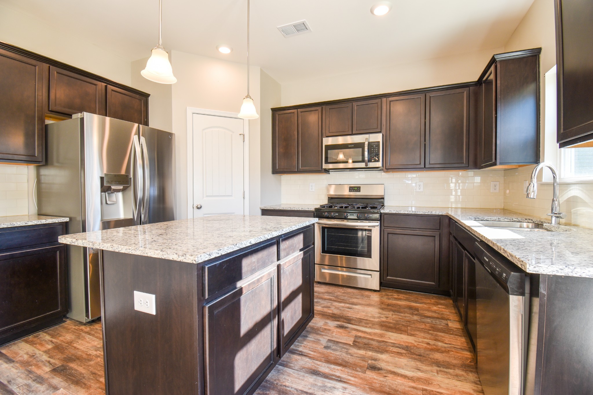 525 Burchell Lane Columbia, TN 38401 - Photo 12 of 29 a kitchen with stainless steel appliances granite countertop a sink stove and refrigerator
