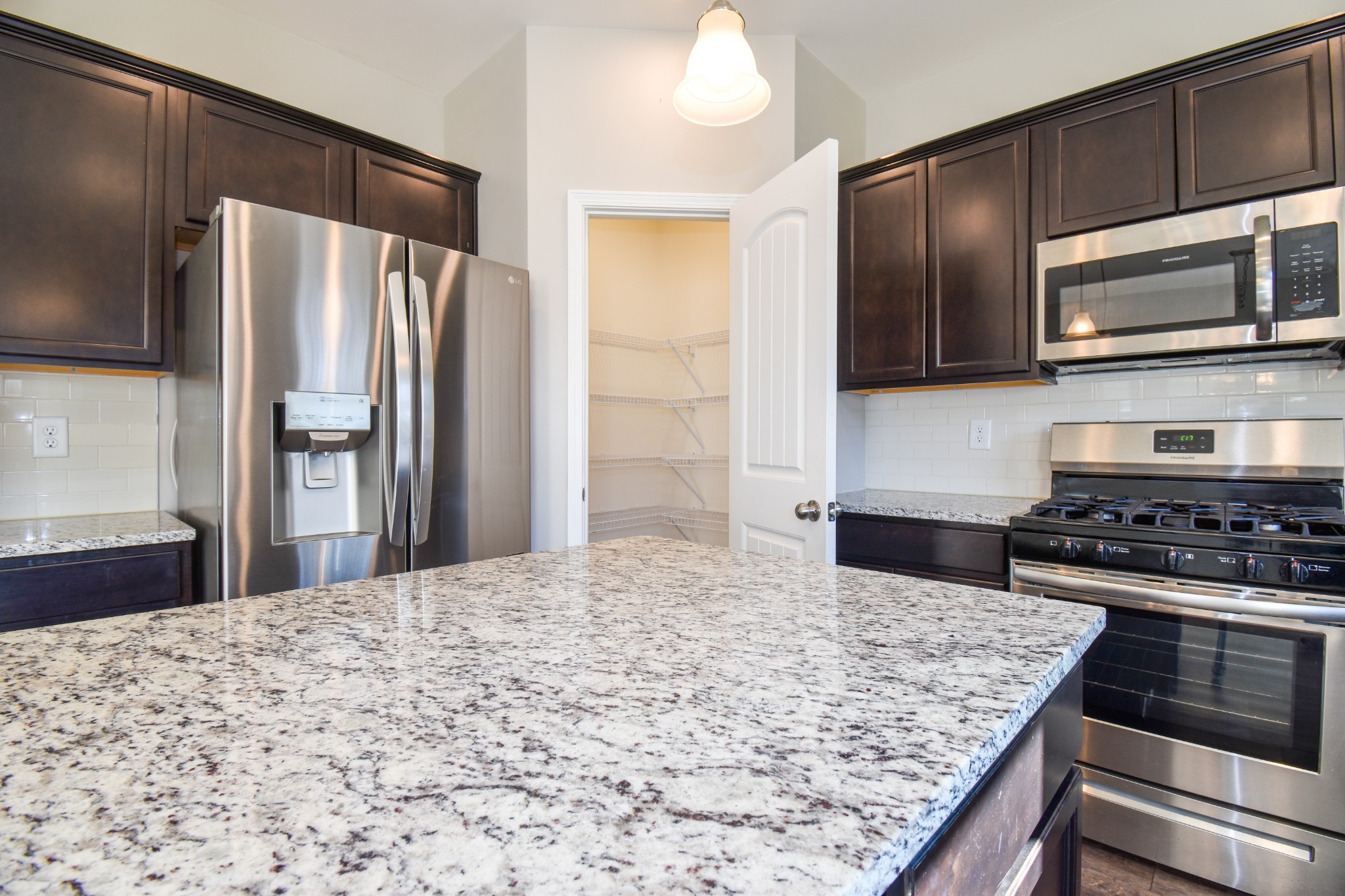 525 Burchell Lane Columbia, TN 38401 - Photo 13 of 29 a kitchen with stainless steel appliances granite countertop a stove refrigerator and microwave
