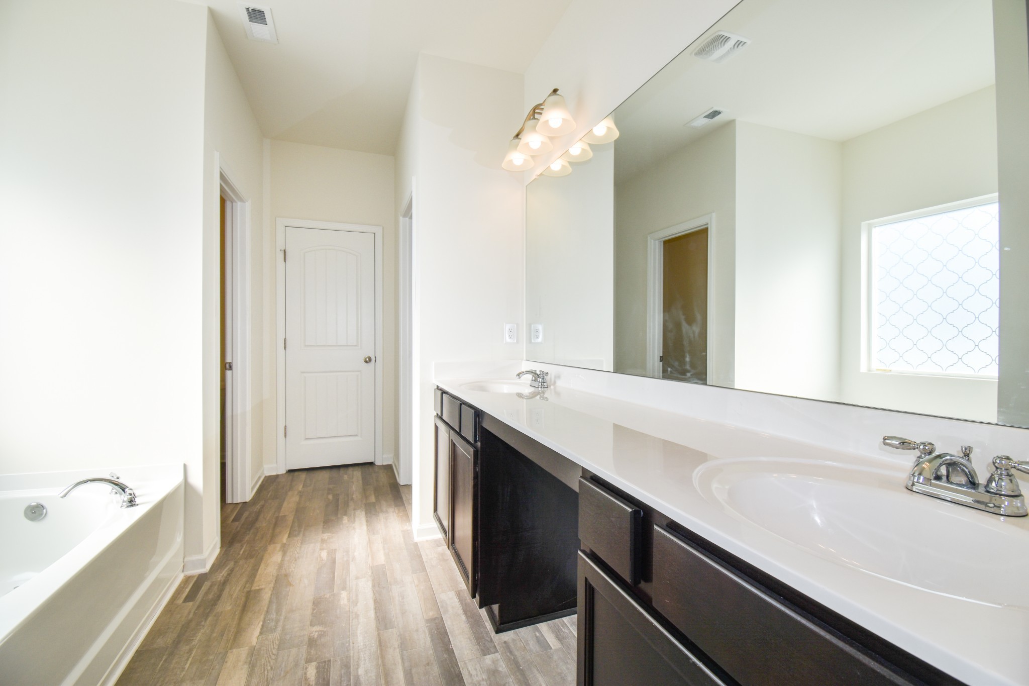525 Burchell Lane Columbia, TN 38401 - Photo 24 of 29 a spacious bathroom with a granite countertop sink a mirror and a bathtub