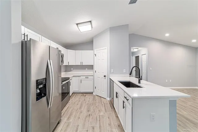 a kitchen with a sink and cabinets