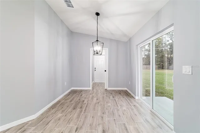 a view of a room with wooden floor water heater and windows