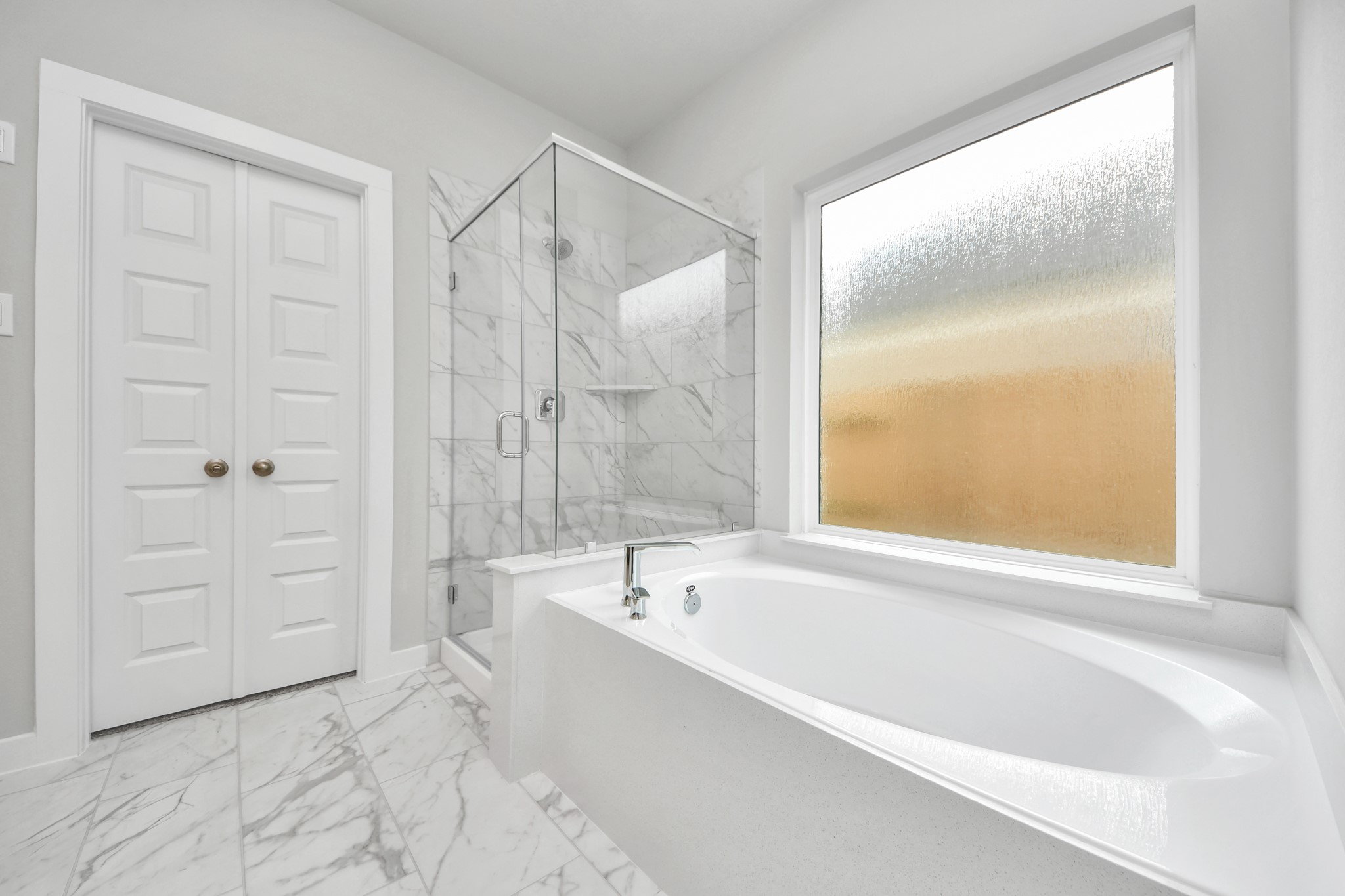11106 Tulip Rdg Trail Houston, TX 77044 - Photo 22 of 34 Indulge in a spa-like retreat within the confines of this primary bathroom. Delight in a spacious walk-in shower enveloped in stylish tile surround, unwind in a separate garden tub adorned with custom detailing. Sample photo of completed home with similar floor plan. Actual colors and selections may vary.