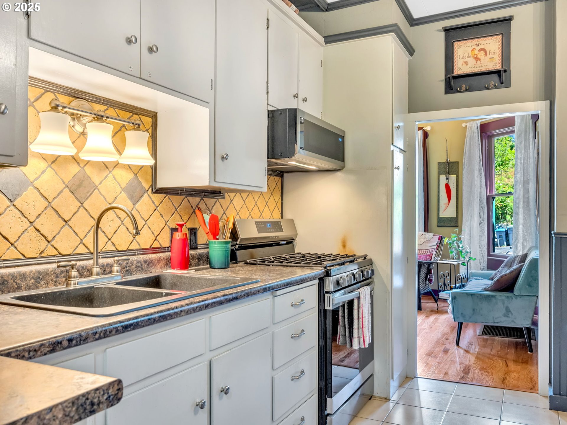 143 Washington Street Astoria, OR 97103 - Photo 11 of 45 a kitchen with stainless steel appliances a sink stove and a window