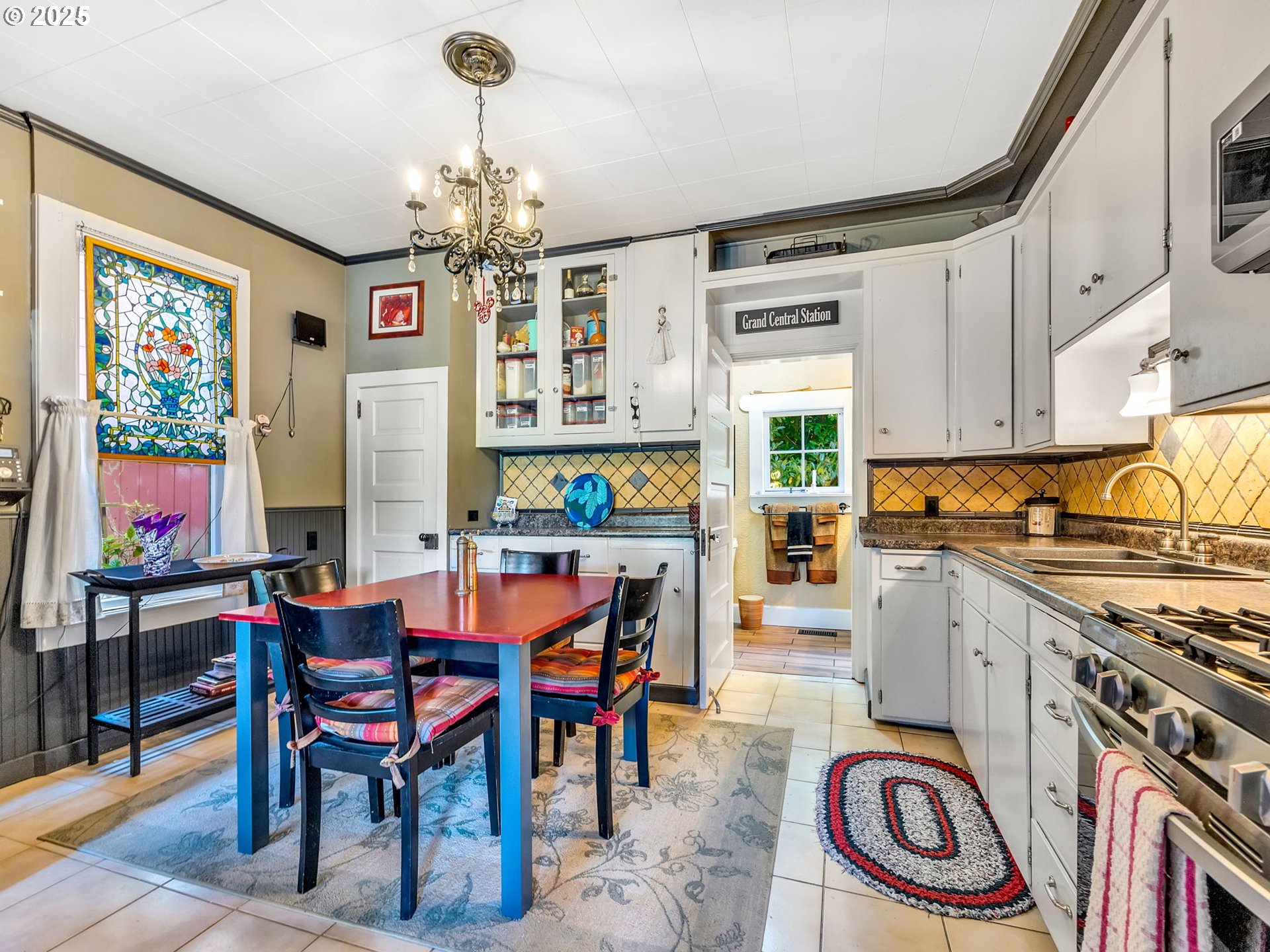 143 Washington Street Astoria, OR 97103 - Photo 12 of 45 a view of a dining room with furniture wooden floor and chandelier