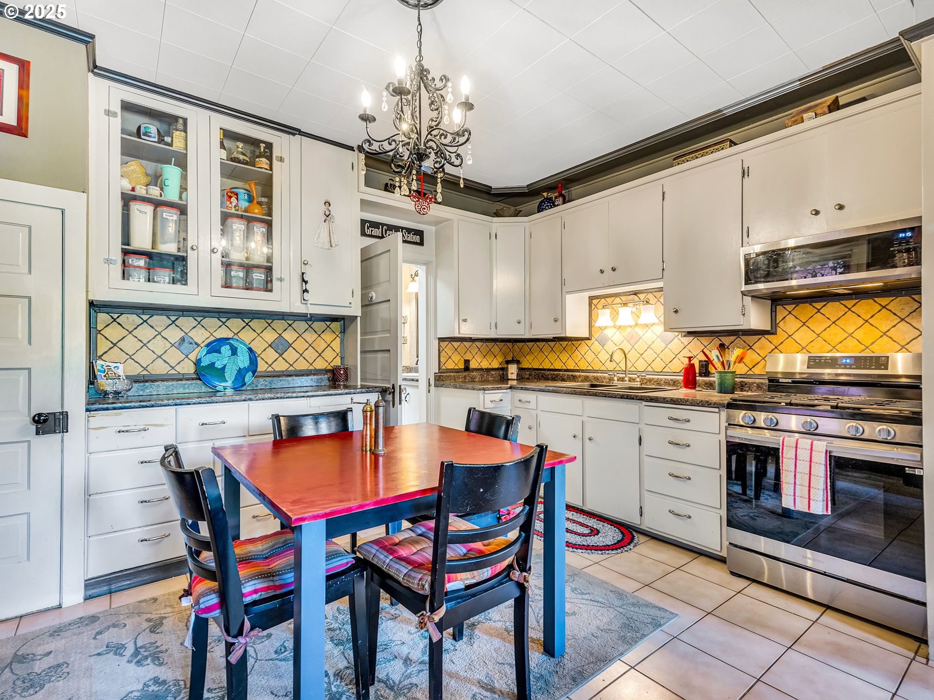 143 Washington Street Astoria, OR 97103 - Photo 13 of 45 a view of a dining room with furniture a chandelier and wooden floor
