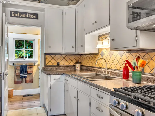 a kitchen with stainless steel appliances granite countertop a stove and a sink