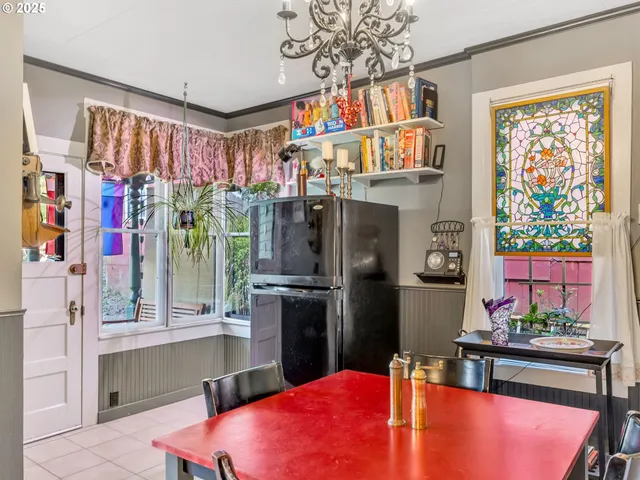a kitchen with stainless steel appliances kitchen island granite countertop a refrigerator and a table