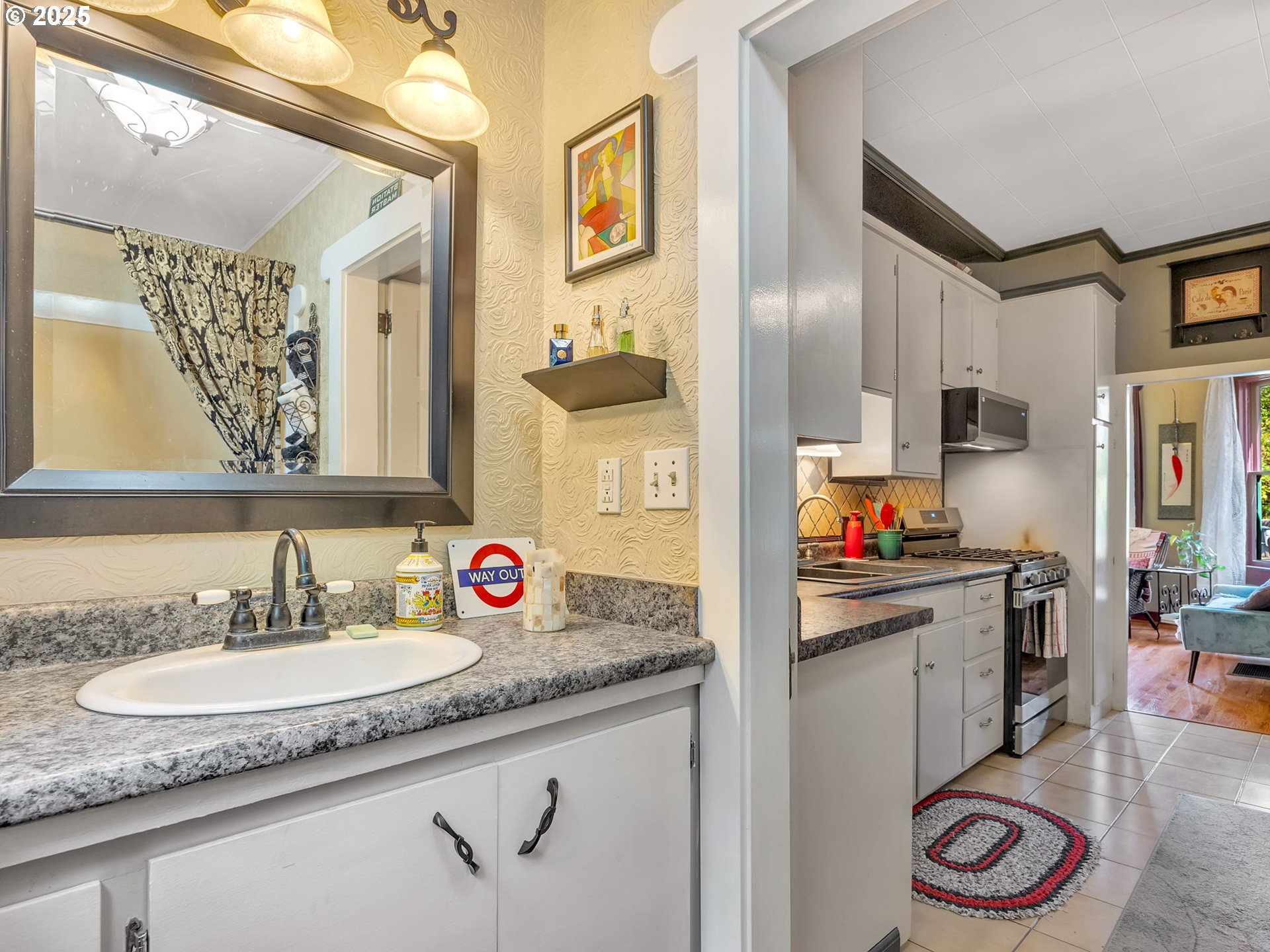 143 Washington Street Astoria, OR 97103 - Photo 18 of 45 a bathroom with a granite countertop sink and a mirror