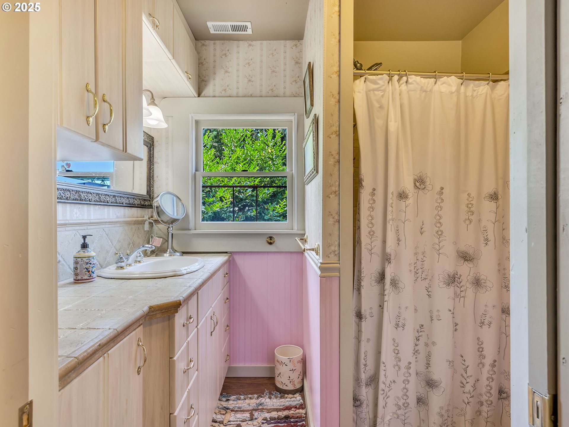 143 Washington Street Astoria, OR 97103 - Photo 31 of 45 a bathroom with a granite countertop sink a vanity and a shower
