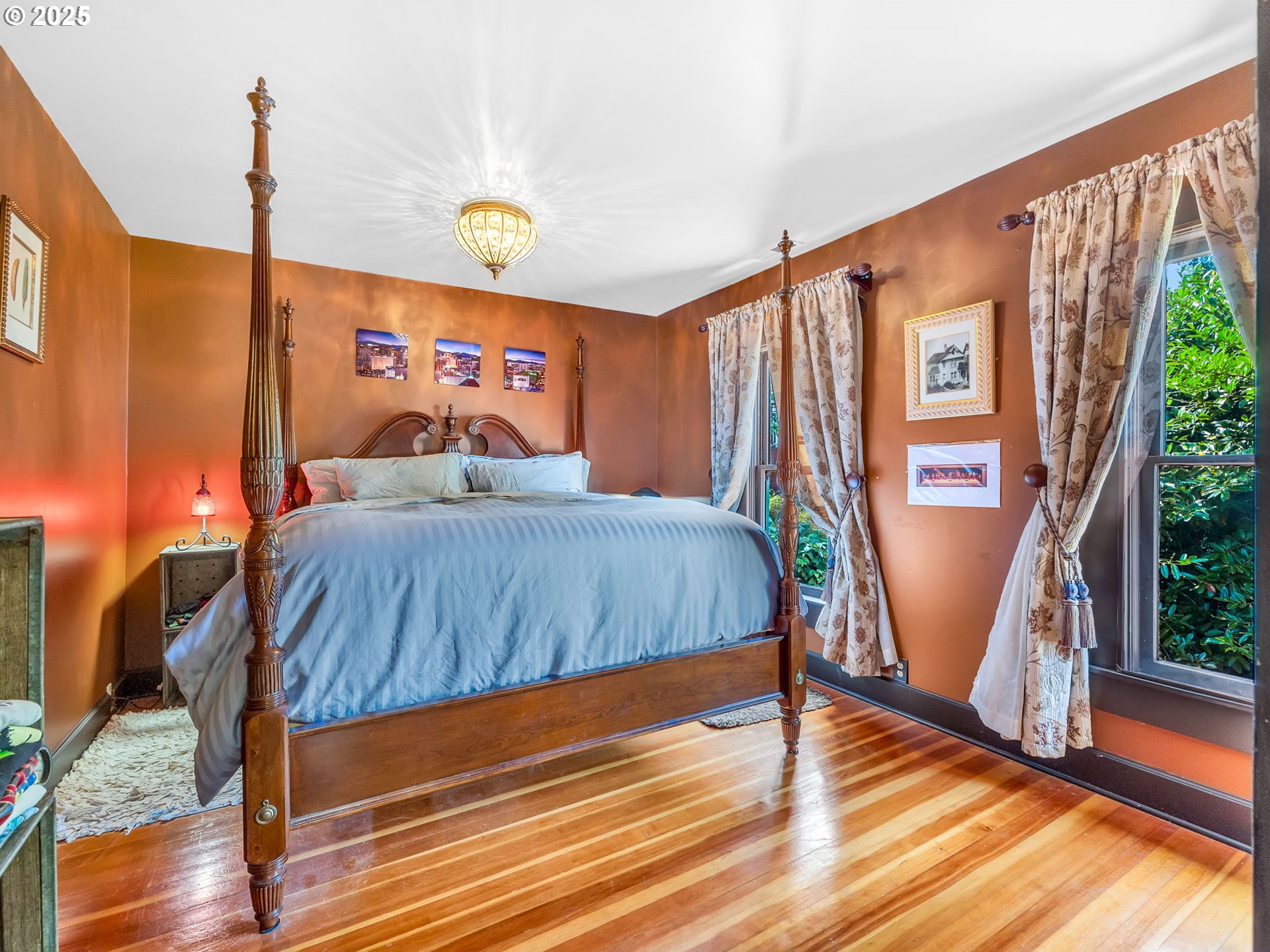 143 Washington Street Astoria, OR 97103 - Photo 32 of 45 a bedroom with a bed window and wooden floor