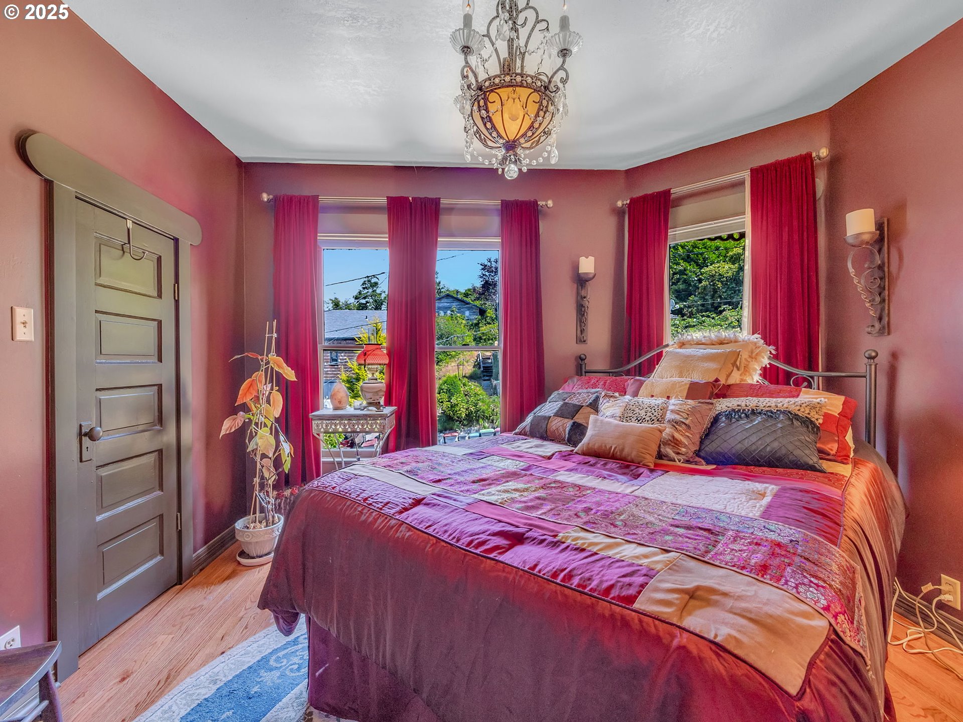 143 Washington Street Astoria, OR 97103 - Photo 35 of 45 a bedroom with a bed and a chandelier