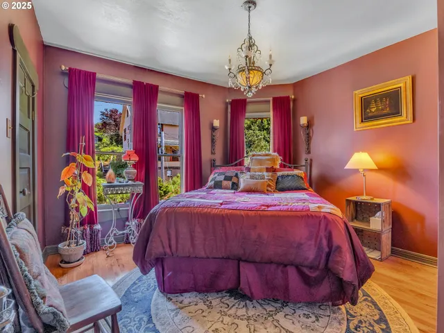 a bedroom with a bed and a chandelier