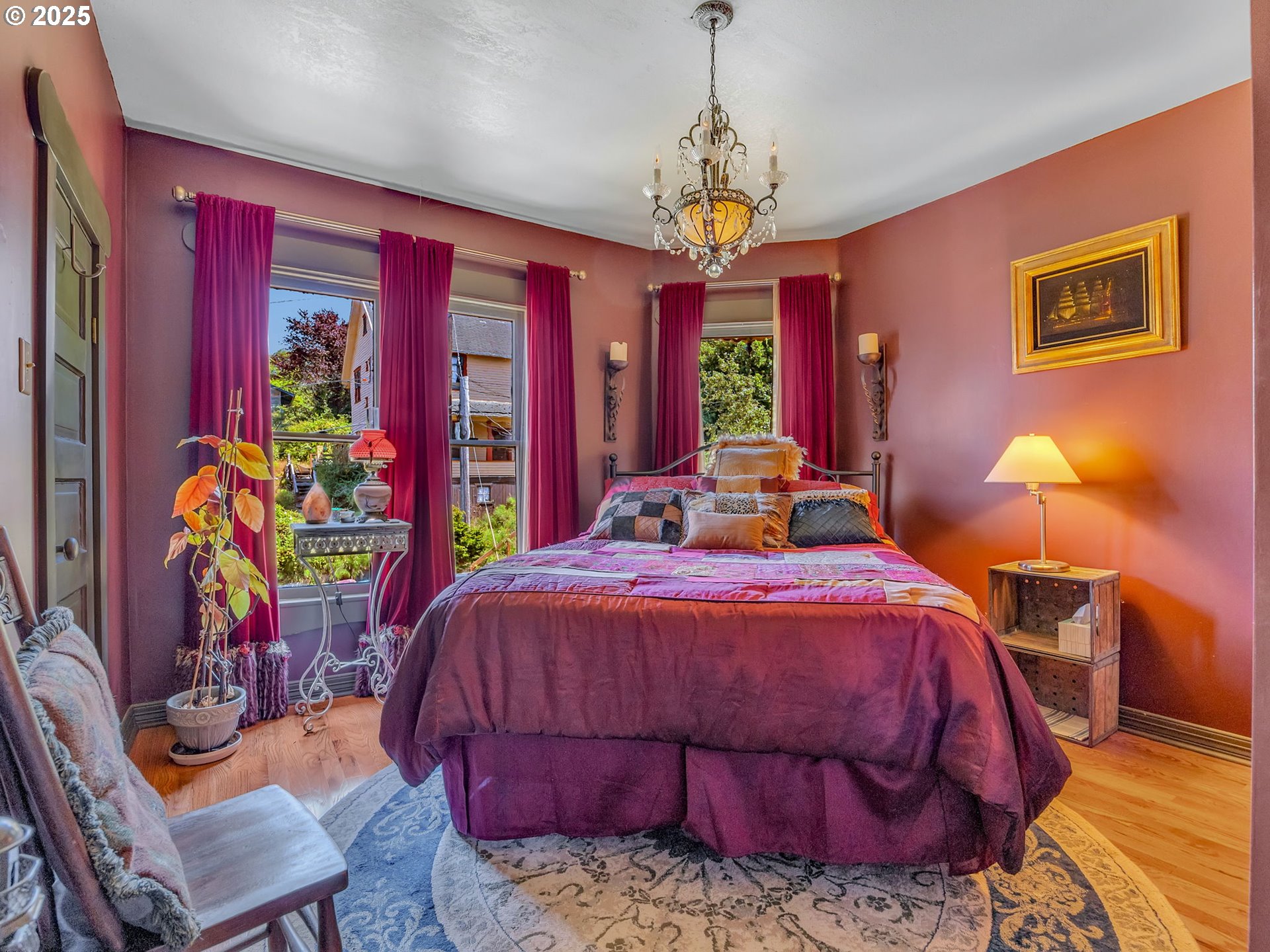 143 Washington Street Astoria, OR 97103 - Photo 36 of 45 a bedroom with a bed and a chandelier