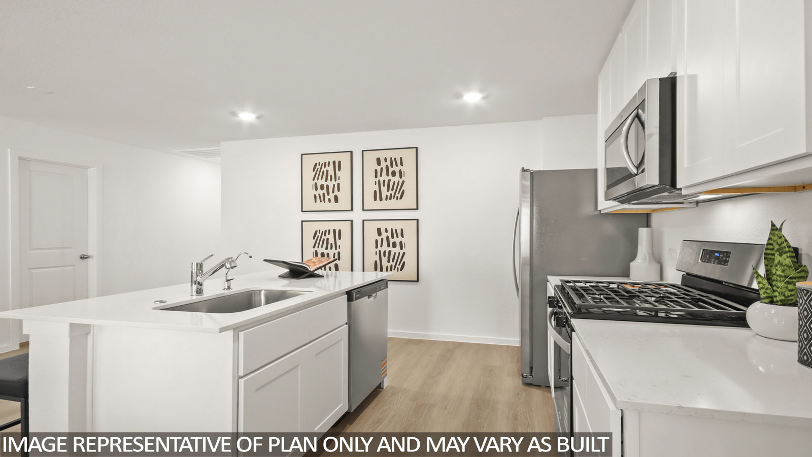129 Baby Calf Roping Road Jarrell, TX 76537 - Photo 8 of 23 Kitchen featuring a center island with sink, stainless steel appliances, white cabinetry, light wood-style floors, and light stone countertops