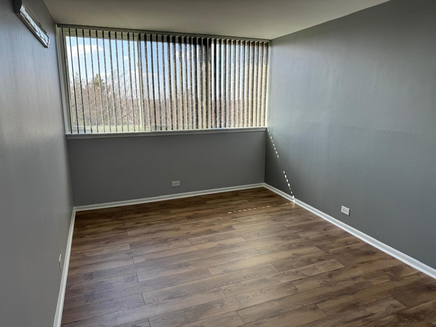 101 Bar Harbour Road, Unit 6A Schaumburg, IL 60193 - Photo 26 of 32 a view of an empty room with wooden floor and a window