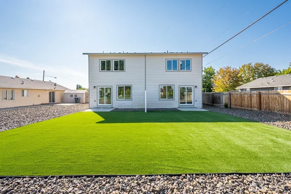 a view of a house with backyard and porch