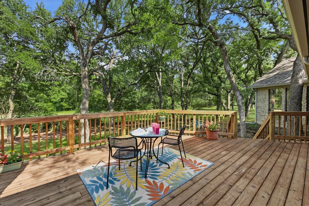 1904 Oak Ridge Trail Bridgeport, TX 76426 - Photo 32 of 40 a view of a deck with furniture and trees in the front
