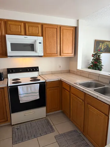 a kitchen with a stove microwave and sink