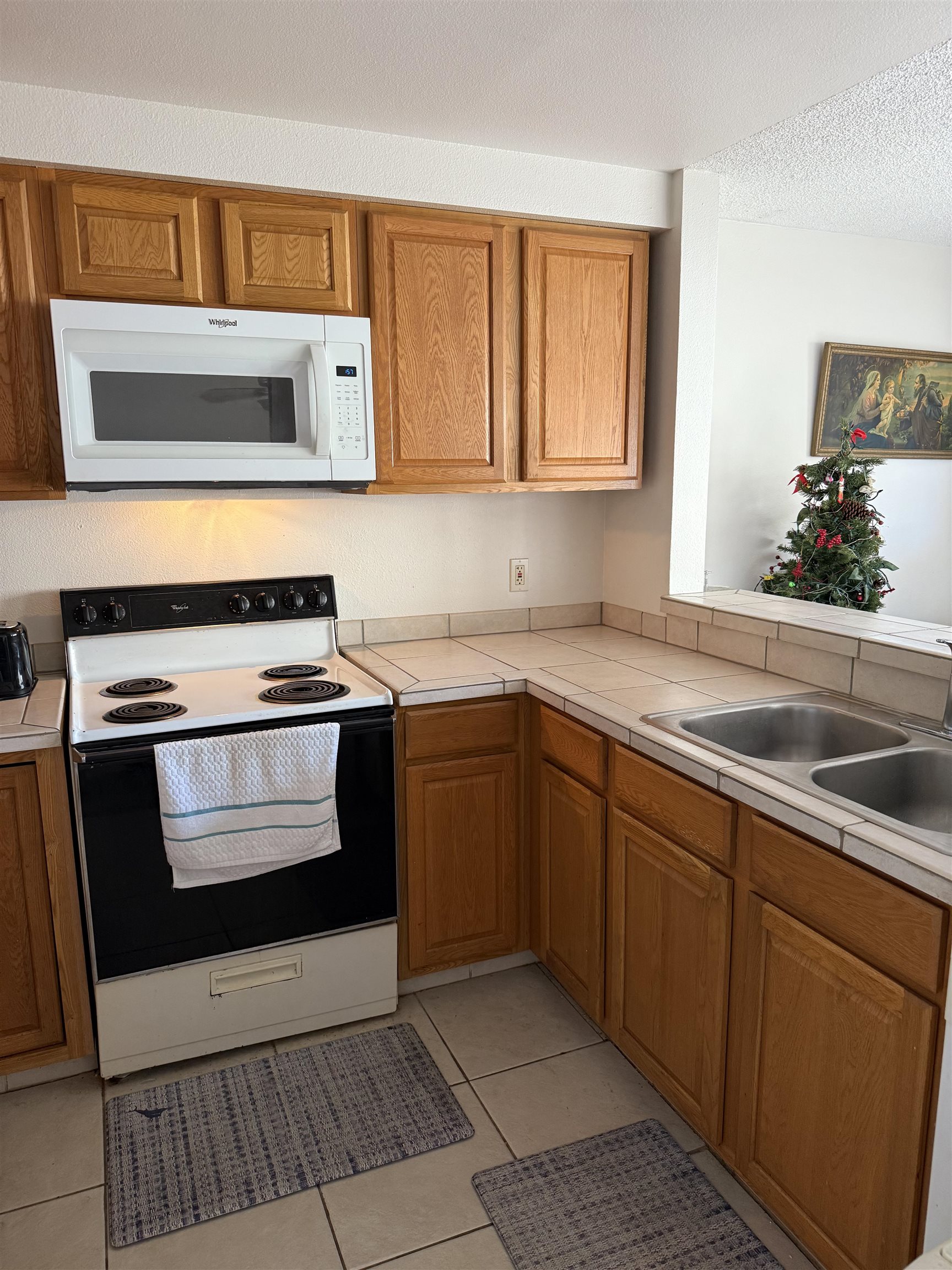 2747 South Kihei Road, Unit A101 Kihei, HI 96753 - Photo 2 of 14 a kitchen with a stove microwave and sink