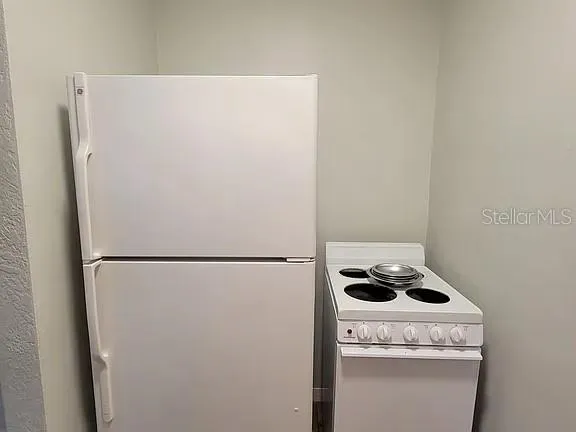 a white refrigerator freezer sitting inside of a kitchen