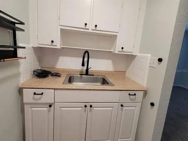 a kitchen with a sink and cabinets
