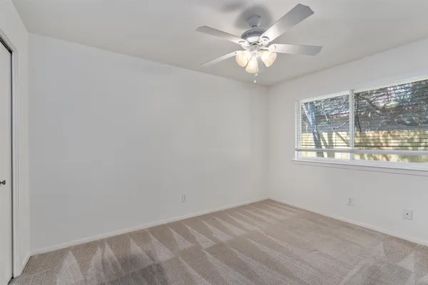 a view of an empty room with a window