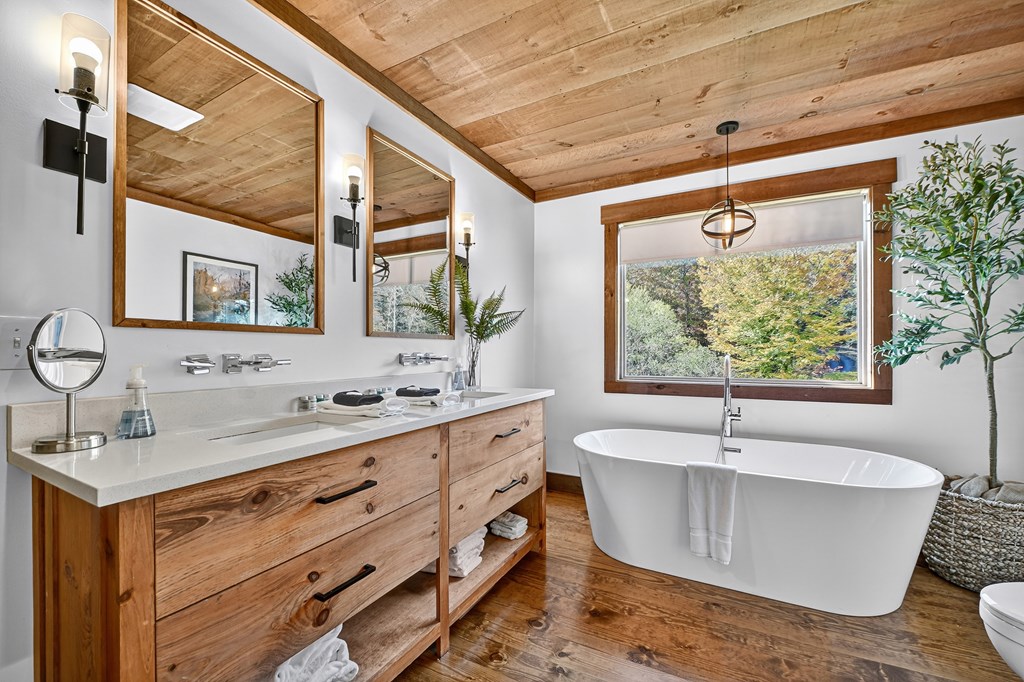 89 High Mdws Drive Morganton, GA 30560 - Photo 31 of 63 a bathroom with a granite countertop sink mirror and a bathtub