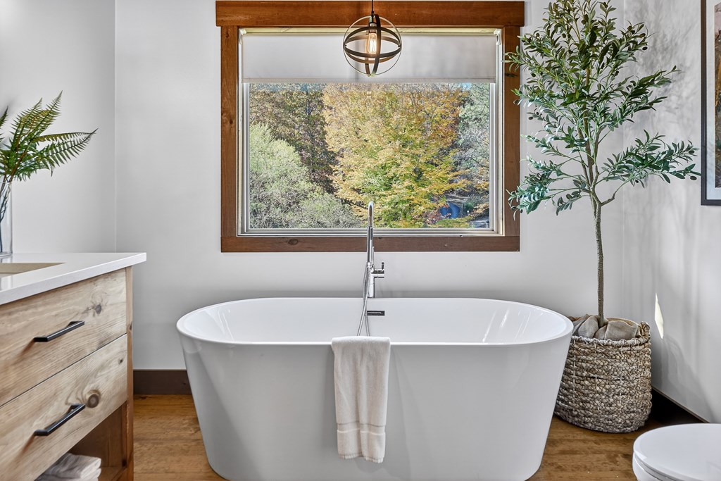 89 High Mdws Drive Morganton, GA 30560 - Photo 32 of 63 a white bath tub sitting in a bathroom next to a window