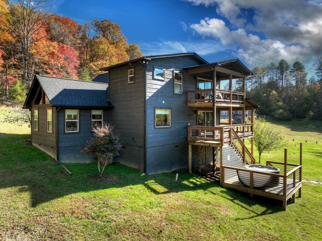 89 High Mdws Drive Morganton, GA 30560 - Photo 5 of 63 a backyard of a house with barbeque oven fire pit table and chairs