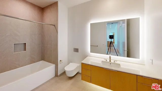 a bathroom with a tub sink and mirror