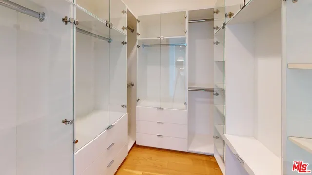 a bathroom with a tub shower vanity and a sink