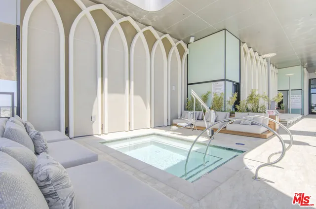 a spacious bedroom with a large window and a bed