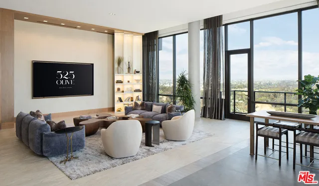 a living room with furniture large windows and wooden floor