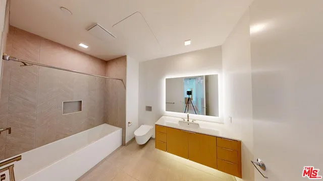 a bathroom with a large tub a sink a vanity and a shower