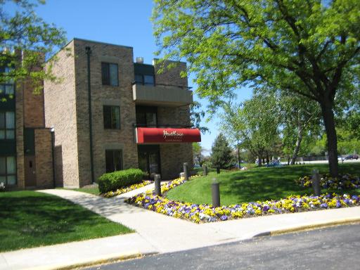 1919 Prairie Square, Unit 313 Schaumburg, IL 60173 - Photo 1 of 1 a front view of a house with a yard