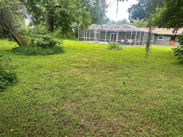 a view of a house with a backyard