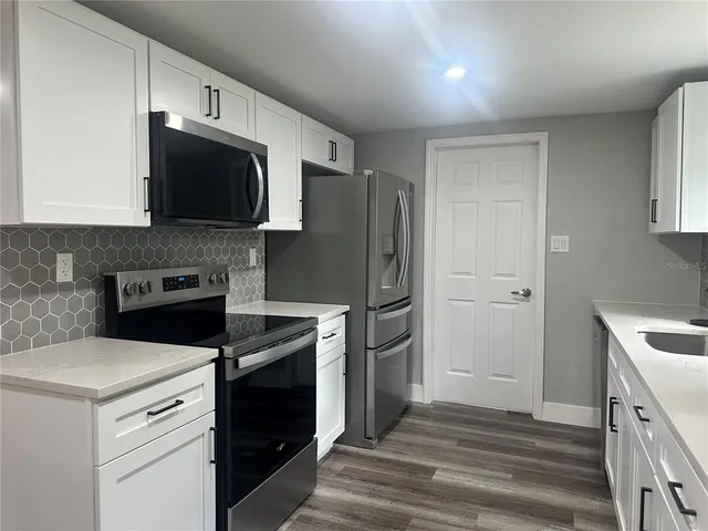 a kitchen with a stove microwave and refrigerator
