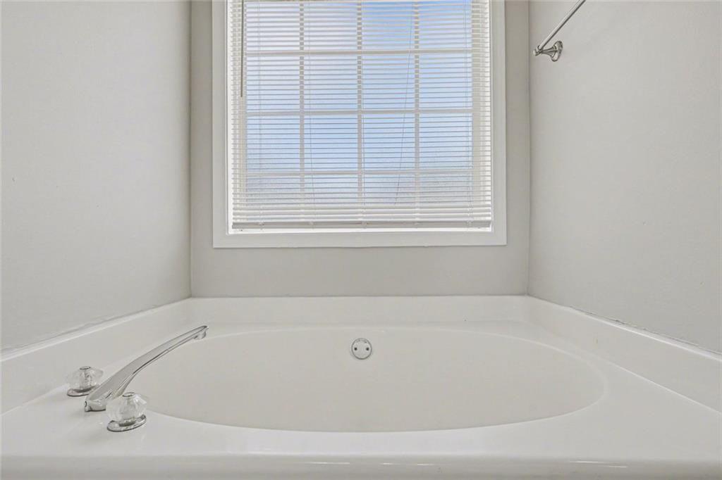 10 Wilbur Way Covington, GA 30016 - Photo 9 of 22 a white bath tub sitting next to a window