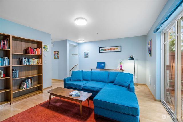 a living room with furniture and a book shelf