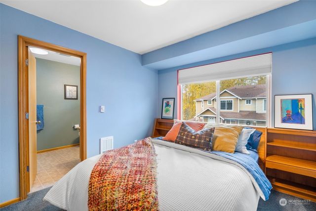 a bedroom with a bed and a large window