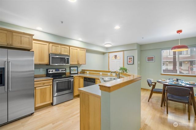 a kitchen with stainless steel appliances granite countertop a stove and a refrigerator