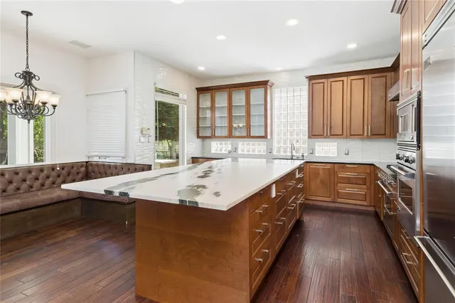 a kitchen with counter top space a sink appliances and cabinets