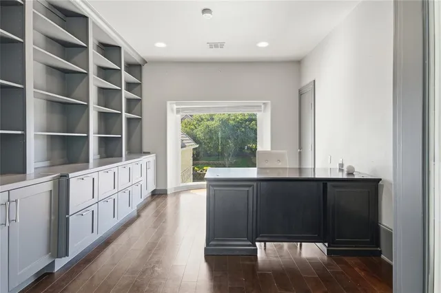 a kitchen with stainless steel appliances granite countertop a stove and a large window