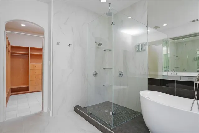 a bathroom with a glass shower door