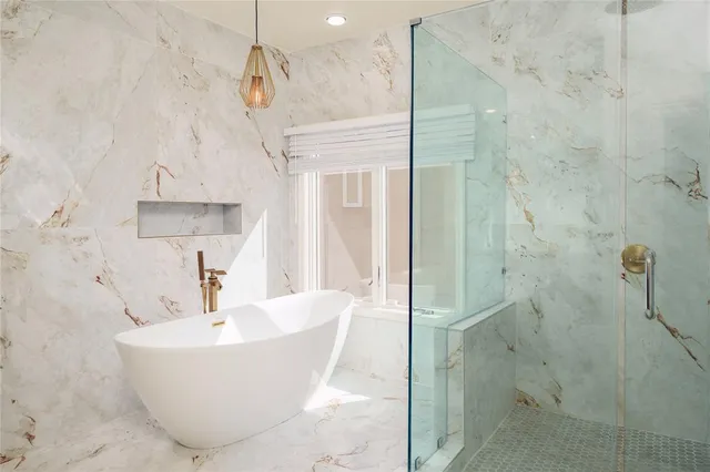 a bathroom with a bathtub and shower
