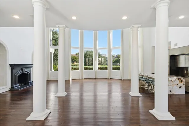 a view of an entryway with wooden floor and a fireplace