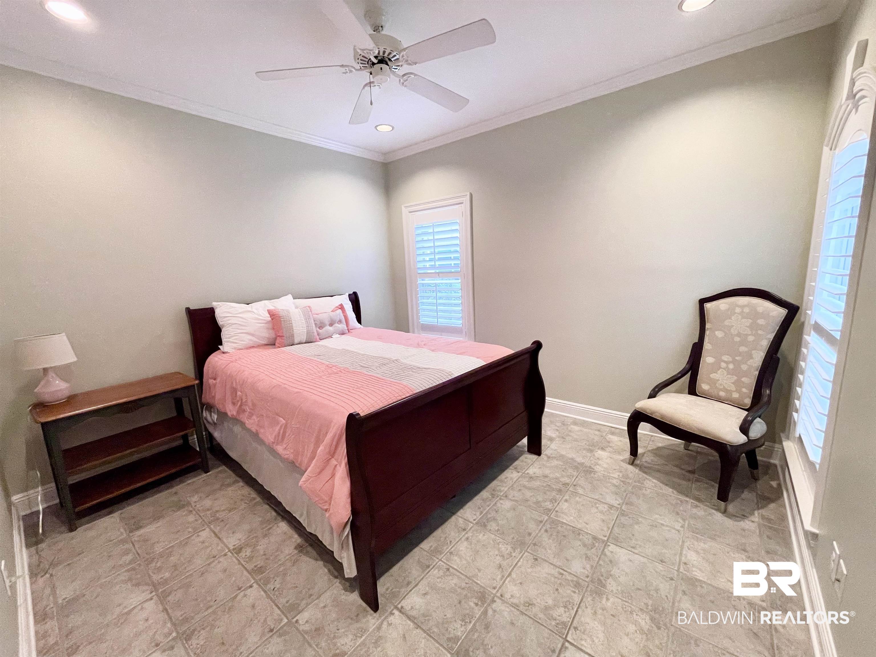 202 Potters Mills Road Daphne, AL 36526 - Photo 18 of 29 Bedroom with tile patterned flooring, crown molding, and ceiling fan